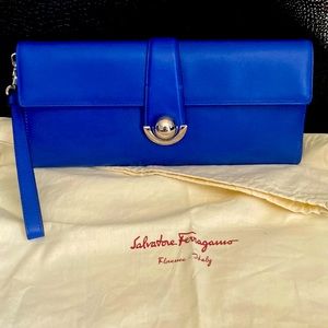 This is a very cute Salvatore Ferragamo clutch in blue color